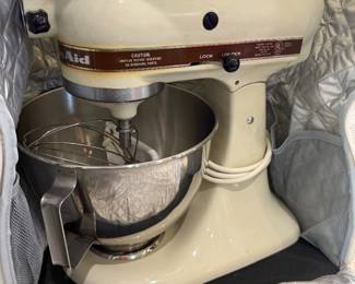 KitchenAid mixer with accessories and storage case