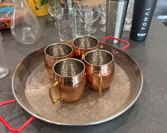 Brass mugs on pizza pan