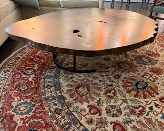 Rough edged wood coffee table with metal legs