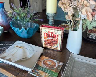 Cookbooks, decor, square plates and faux plants
