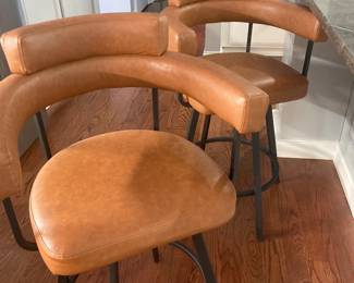 Four (4) leather counter stools.