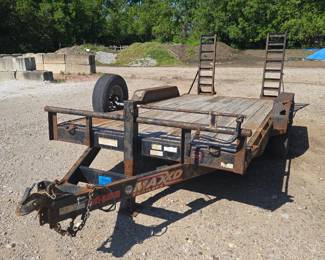 Maxey utility trailer with wooden deck and attached loading ramps