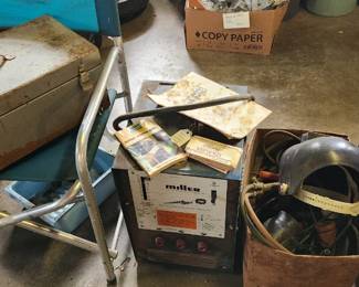 Beach chairs, metal tool boxes, Miller welder, welding cables and helmet and manuals
