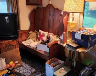 Vintage stereo cabinrecord player, tv, highback bench seat, pillows, vintage amber glass lamp, books, artwork, metronome