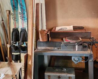 Vintage water skis, shop vac , Rockwell Delta jointer with accessories and manual, boat paddles, vintage metal tool box, hotdogs and marshmallow roasting sticks, storm doorss