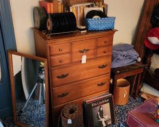 Tripod, mirror, dresser, albums,  45s, cds, trucker hats, Rubic cube, braided rug,  bed