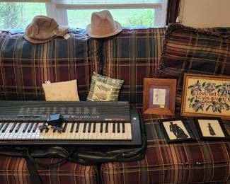Sofa, electric keyboard, pillows, artwork, mens hats and military cap