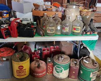Vintage gas/petroleum cans, battery chargers, jump starters, vintage vinegar and cider jugs, vintage churn crock, men's vintage skates