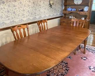 -	1968 Colonial/Early American maple dining room set, stamped OLD AMBER- buffet, hutch, 3 leaf table with at least 4 Windsor chairs. Made by St. Johns table company in Cadillac, MI