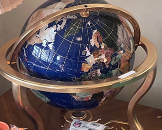 Lapis, precious stone, and brass globe. 