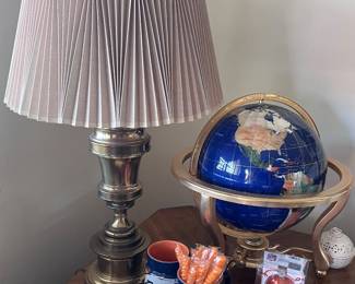 Brass lamps, lapis globe, encyclopedias. 