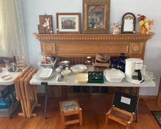 Household items, including a Pyrex set and some art on the mantle.