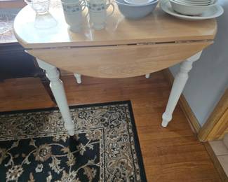 Round kitchen table with drop leaves.