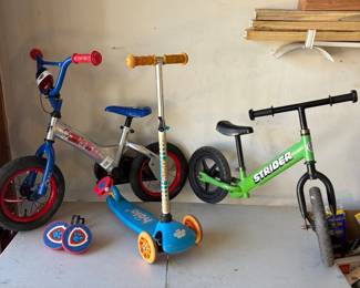 kk Kids Bike and Scooter Lot  Includes Blue Paw Patrol Bike, Green Strider Balance Bike, and Blue Halo Scooter