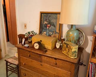 Antique dresser, lamp, clocks, art