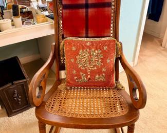 Vintage rocking chair with cane webbing on seat and headrest. Farmhouse/Colonial style.