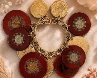 Gold tone bracelet with poker chips from France and Morocco and Fran Dash coins