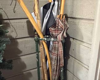 ANTIQUE CAST IRON UMBRELLA CANE STAND WITH VARIOUS ITEMS