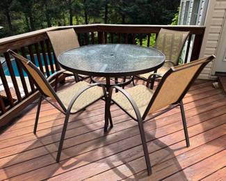 Outdoor Round Glass Top Patio Table (47"D x 28"H) with Outdoor Stackable Patio Armchairs (6 Total)