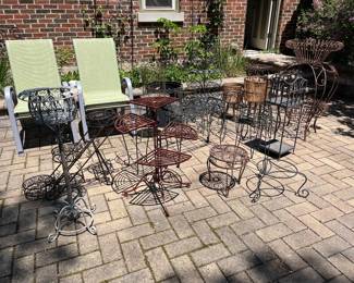 Loads of metal plant stands, planters, tiered plant displays, etc