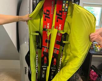 Downhill skis, poles, travel bag