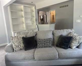 🛋️ Modern Light Gray Sofa with Accent Pillows 🛋️  Beautiful contemporary sofa featuring a clean light gray fabric design with plush seating and stylish accent pillows included. Comfortable, spacious, and versatile — perfect for a living room, family room, or modern apartment setup.  ✨ Soft light gray upholstery ✨ Includes decorative accent pillows ✨ Deep, comfortable seating ✨ Modern and elegant design ✨ Excellent overall condition  A stylish and cozy centerpiece ready for any home décor.