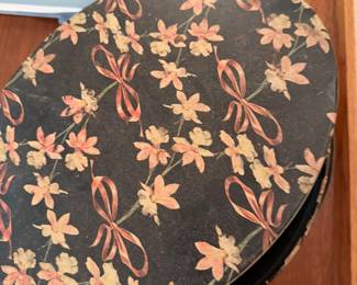 vintage Hanae Mori lacquered vanity nesting box features a floral pattern with gold ribbons on a black background