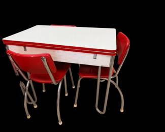 This is red and white enamel top table with four chairs