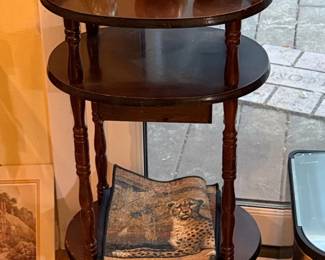 Vintage ThreeTiered Pedestal Table with Pig Figurines and Leopard Tapestry