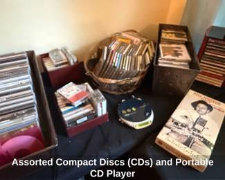 Assorted Compact Discs CDs and Portable CD Player