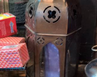 Ornate Metal Lantern with Decorative Cutouts and Purple Candle