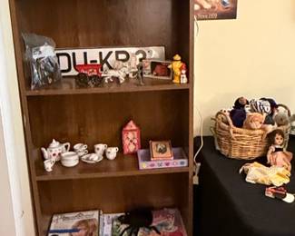 Assorted Collectibles Displayed on Wooden Bookshelf