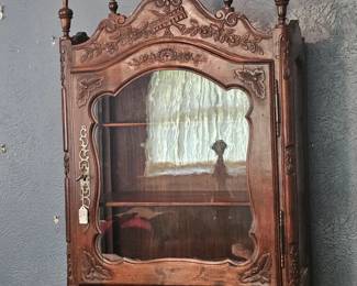 An ornate 18th-century French Louis XV style walnut vitrine display cabinet.