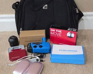 Lot #86 - Travel Supplies - Swiss Army Knife, Crank Radio, Travel Adapter, Rechargeable Hand Warmers, Solar Charger & More