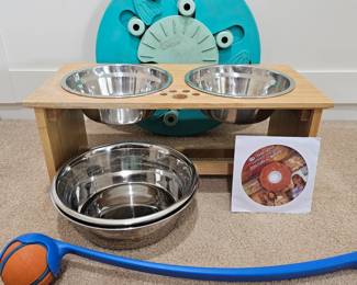 Lot #118 - Elevated Dog Feeder with Stainless Steel Bowls, Dog Care Training DVD, Interactive Treat Puzzle, Chuck-It Ball Throw