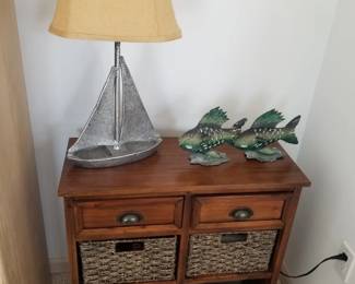 Two=drawer cupboad with storage baskets; sailboat table lamp