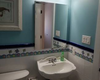 Pedestal sink; mirror; vanity lights