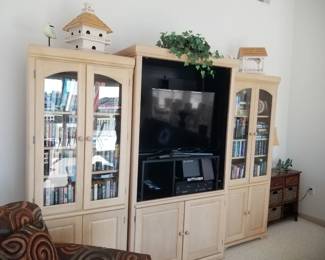 Wall unit consists of three sections - two glass front cabinets & one media cabinet
