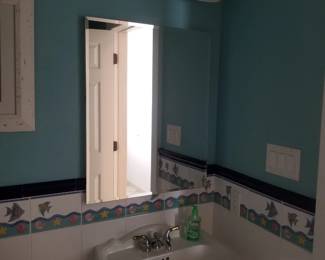 Pedestal sink; mirror; vanity lights
