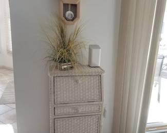 Wicker one-drawer cupboard; wall clock