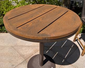 JANUS Et Cie Teak Bistro Table With Power Coated Steel Base - 2 Available. Measures 36" D x 42" H. The Tables Are In Great Condition. No Bistro Chairs.  Photo 2 of 2. 