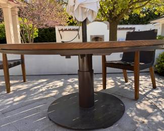 JANUS Et Cie 60" Round Teak Dining Table With Power Coated Steel Base - 2 Available. Measures 30" H. The Tables Are In Great Condition.  Photo 1 of 4.  