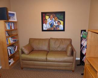 Sleep sofa, bookcase, books, framed picture