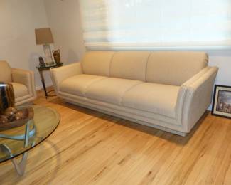Neutral modern sofa, small side table, lamp