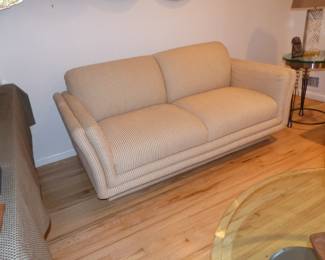 Neutral modern loveseat, small side table, lamp