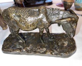 Bronze sculpture of grazing goat