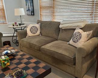 Green Crate and Barrel Prado sofa with decorative pillows