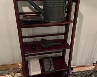 Walnut shelving unit with watering can on top