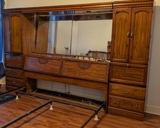 King size, armoire on each side. Headboard opens for storage. Mirror with lights above.
