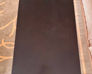 Ebonized Wood Coffee Table with Gold Tone Distressed Trim on Edge and Tapered Urn-Style Legs. Measures 28" x 48" x 19.5" H. Photo 3 of 5.